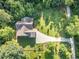 Aerial perspective of a home with a well-maintained lawn and a gravel driveway at 136 Vireo Ln, Hillsborough, NC 27278