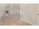 Finished attic space with neutral walls, carpeting, track lighting and window at 136 Vireo Ln, Hillsborough, NC 27278