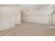 Finished attic space with neutral walls, carpeting, track lighting and window at 136 Vireo Ln, Hillsborough, NC 27278