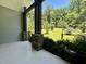 Covered porch with stone posts and gorgeous views of the manicured lawn and surrounding trees at 136 Vireo Ln, Hillsborough, NC 27278