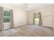 Bedroom featuring carpeted floor and two windows with tree views at 136 Vireo Ln, Hillsborough, NC 27278