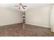 Neutral bedroom showcasing hardwood floors, a ceiling fan, and a view of the home's hallway at 136 Vireo Ln, Hillsborough, NC 27278