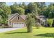 Charming exterior view of home featuring a two-car garage and well-kept lawn at 136 Vireo Ln, Hillsborough, NC 27278