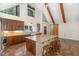 Bright kitchen boasts wooden cabinets, granite counters, island with seating, and abundant natural light at 136 Vireo Ln, Hillsborough, NC 27278