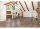 Open living and kitchen space with beautiful wood beams, bar seating, and stainless steel appliances at 136 Vireo Ln, Hillsborough, NC 27278