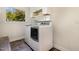 Laundry room with washer, dryer, tile flooring, and built-in storage at 136 Vireo Ln, Hillsborough, NC 27278