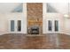 Spacious living room with stone fireplace, vaulted ceilings, and lots of natural light at 136 Vireo Ln, Hillsborough, NC 27278