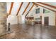 Open concept living space featuring wood beams, a stone fireplace, and updated kitchen at 136 Vireo Ln, Hillsborough, NC 27278