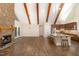 Open floorplan featuring stone fireplace, hardwood floors, and modern kitchen appliances and cabinetry at 136 Vireo Ln, Hillsborough, NC 27278