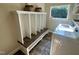 Mudroom features a built-in bench, storage hooks, and a tile floor by the washer and dryer at 136 Vireo Ln, Hillsborough, NC 27278