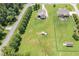 An aerial view displays a spacious property with lawn and a road lined with trees at 14 Water Front Ln, Timberlake, NC 27583
