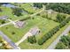 Aerial view of the property showcasing the home, yard, and surrounding neighborhood with a pond at 14 Water Front Ln, Timberlake, NC 27583