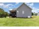View of a well-maintained backyard featuring a screened porch on a gray two-story home at 14 Water Front Ln, Timberlake, NC 27583