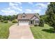 Charming gray two-story home with stone accents, a two-car garage, and a well-manicured front lawn at 14 Water Front Ln, Timberlake, NC 27583