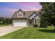 Charming gray two-story home with stone accents, a two-car garage, and a well-manicured front lawn at 14 Water Front Ln, Timberlake, NC 27583