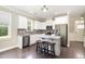 Modern kitchen with stainless steel appliances, white cabinets, and a marble-topped island with seating at 14 Water Front Ln, Timberlake, NC 27583