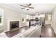 Open-concept living space featuring a stone fireplace and an adjacent kitchen with stainless steel appliances at 14 Water Front Ln, Timberlake, NC 27583