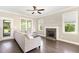 Inviting living room with fireplace, large windows, and comfortable seating, perfect for relaxation at 14 Water Front Ln, Timberlake, NC 27583