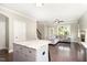 Open concept kitchen with island flows into the living room with cozy couch at 14 Water Front Ln, Timberlake, NC 27583