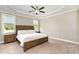 Spacious main bedroom with tray ceiling, plush carpeting, and large windows offering plenty of natural light at 14 Water Front Ln, Timberlake, NC 27583
