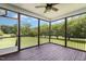 Relaxing screened-in porch offers serene views of the lush backyard, perfect for outdoor enjoyment at 14 Water Front Ln, Timberlake, NC 27583