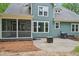 View of home's rear exterior showcasing patio, grill and spacious backyard at 1419 Endgame Ct, Wake Forest, NC 27587