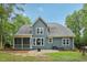 Rear exterior view of the home with a patio, grill and a spacious backyard at 1419 Endgame Ct, Wake Forest, NC 27587