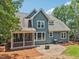 Blue house exterior with back patio, outdoor grill, and large backyard at 1419 Endgame Ct, Wake Forest, NC 27587