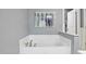 Relaxing bathtub with stylish fixtures and neutral walls at 1419 Endgame Ct, Wake Forest, NC 27587