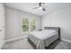 This bedroom features neutral walls, a ceiling fan, and a window with views of the outdoors at 1419 Endgame Ct, Wake Forest, NC 27587