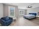 Spacious bedroom with large windows, a plush armchair, and wood floors at 1419 Endgame Ct, Wake Forest, NC 27587