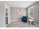 Sitting area with gray walls, vinyl floors, accent chair, small table, painting, and access to the bathroom at 1419 Endgame Ct, Wake Forest, NC 27587