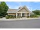 Exterior of community clubhouse with stone accents, white pillars, and manicured landscaping at 1419 Endgame Ct, Wake Forest, NC 27587