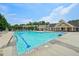 Community pool surrounded by lounge chairs and mature trees on a sunny day at 1419 Endgame Ct, Wake Forest, NC 27587