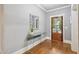 Bright foyer with wood floors, glass door, modern console table, decorative mirror, and neutral color scheme at 1419 Endgame Ct, Wake Forest, NC 27587