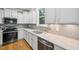 Close-up of kitchen showing white cabinets, stainless steel appliances, granite countertops and stainless steel sink at 1419 Endgame Ct, Wake Forest, NC 27587