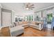 Spacious living room with a large sectional sofa, hardwood floors, and open view to the kitchen at 1419 Endgame Ct, Wake Forest, NC 27587