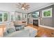 Cozy living room featuring a fireplace, large sectional sofa, hardwood floors, and ample natural light at 1419 Endgame Ct, Wake Forest, NC 27587