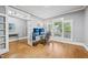 Open office space with hardwood floors, large windows, modern desk setup and french doors at 1419 Endgame Ct, Wake Forest, NC 27587
