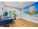 Bright office featuring hardwood floors, a modern desk setup, and unique wall art at 1419 Endgame Ct, Wake Forest, NC 27587
