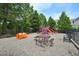 Community playground featuring slides, play equipment, picnic tables and benches surrounded by mature trees at 1419 Endgame Ct, Wake Forest, NC 27587