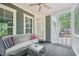 Cozy screened porch with comfortable seating, side table, and wooded views at 1419 Endgame Ct, Wake Forest, NC 27587