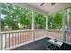 View of the screened porch, with white railing, overlooking wooded back yard at 1419 Endgame Ct, Wake Forest, NC 27587