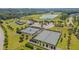 Amazing aerial view of the community tennis and sports courts and the adjacent pond surrounded by lush landscaping at 149 N Serenity Hill Cir, Chapel Hill, NC 27516