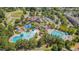 Beautiful aerial view of a community pool area with several pools, a slide, and a clubhouse at 149 N Serenity Hill Cir, Chapel Hill, NC 27516