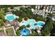 Overhead view of neighborhood pools, including a splash pad and long pool, surrounded by umbrellas and trees at 149 N Serenity Hill Cir, Chapel Hill, NC 27516