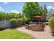 Landscaped backyard featuring a circular seating area, mature trees, and a well-maintained lawn at 149 N Serenity Hill Cir, Chapel Hill, NC 27516