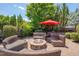 Outdoor fire pit with seating, surrounded by lush landscaping, creating a cozy gathering spot at 149 N Serenity Hill Cir, Chapel Hill, NC 27516