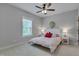 Bright bedroom with neutral walls, a patterned bedspread, and a window offering ample natural light at 149 N Serenity Hill Cir, Chapel Hill, NC 27516