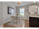 Bright breakfast nook featuring a wood table and chairs next to a gourmet kitchen at 149 N Serenity Hill Cir, Chapel Hill, NC 27516